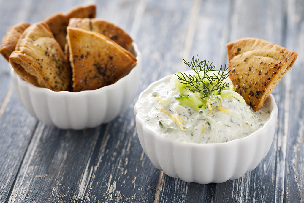 Pita chips in a bowl and dip.